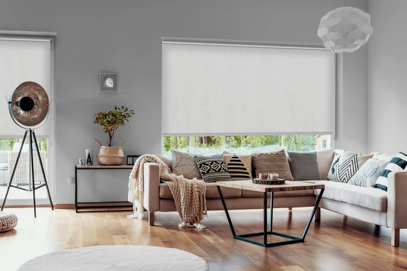 View outside to the green woods through large glass windows in a