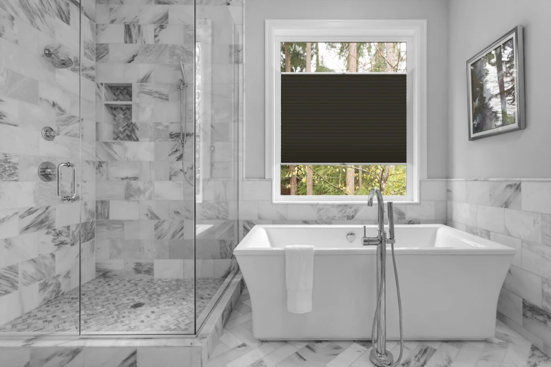 Bathroom with bathtub and shower in new luxury home with all gla