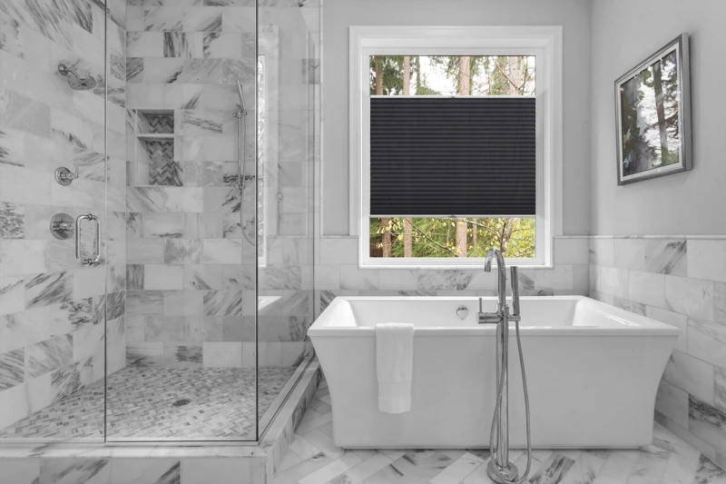 Bathroom with bathtub and shower in new luxury home with all gla