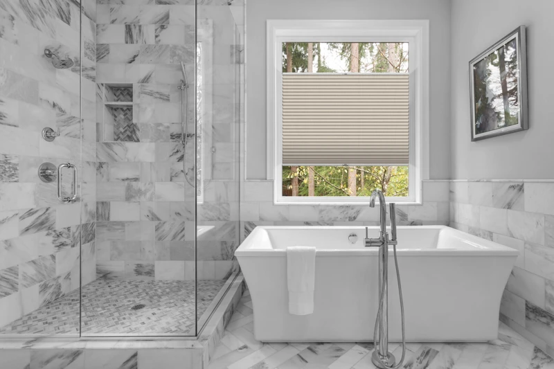 Bathroom with bathtub and shower in new luxury home with all gla