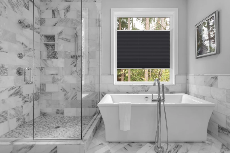 Bathroom with bathtub and shower in new luxury home with all gla