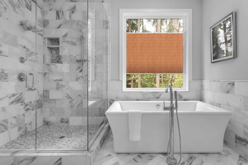 Bathroom with bathtub and shower in new luxury home with all gla