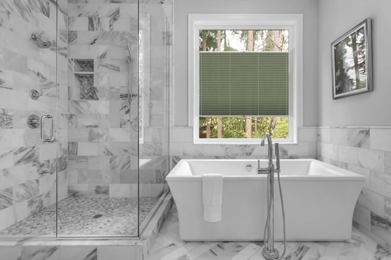 Bathroom with bathtub and shower in new luxury home with all gla