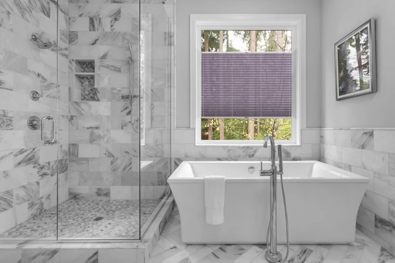 Bathroom with bathtub and shower in new luxury home with all gla