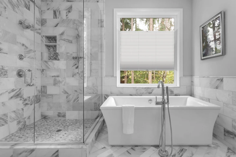 Bathroom with bathtub and shower in new luxury home with all gla