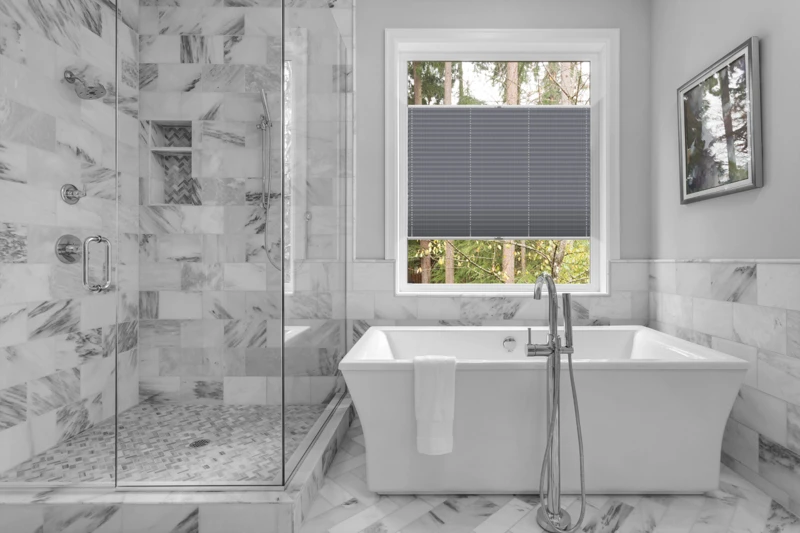 Bathroom with bathtub and shower in new luxury home with all gla