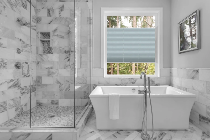 Bathroom with bathtub and shower in new luxury home with all gla